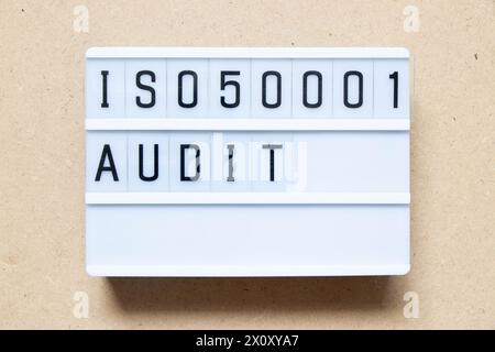 Lightbox with word ISO 50001 audit on wood background Stock Photo