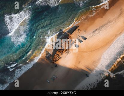 K'gari High angle aerial bird's eye drone view of the Maheno shipwreck on Seventy-Five Mile Beach on Fraser Island, Queensland, Australia. Beautiful Stock Photo