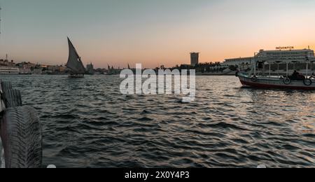 Sunset on the Nile in Aswan with Moevenpick Hotel Stock Photo