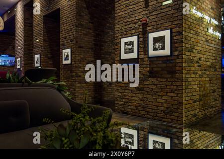 "... because every picture tells a story." Lobby of the Radisson Blue Aqua Hotel. The hotel is known for its modern design. Photos by photographer Vivian Maier hang in the lobby of the hotel, which was designed by architect Jeanne Gang in 2009. Chicago, Illinois, United States Stock Photo