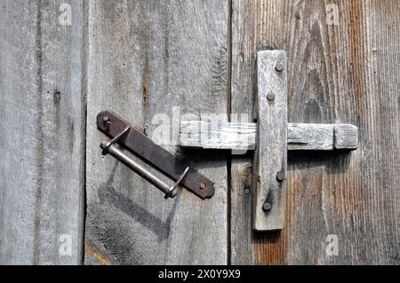 Old lock on the door. Locking device of an old farmhouse. Background. Stock Photo