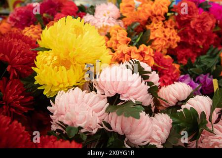 Decorative colorful Floral wall background.  various colorful plastic flower Stock Photo