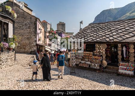 Mostar, Bosnia and Herzegovina, August 13, 2023. Group of Locals Walking Down a Cobblestone Street in Mostar Stock Photo