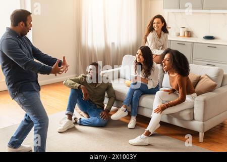 Group of friends enjoying storytelling and reactions Stock Photo