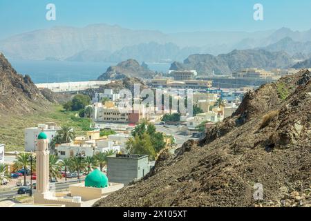 Muscat Takia historical city center streets overview panorama with green mosque some, rocks and arabian sea in the background, Oman Stock Photo
