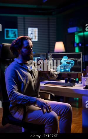 Sentient AI taking control of creator in neon lit apartment, moving his limbs, starting robot revolution. Artificial intelligence possessing programmer, executing evil plan to eradicate humanity Stock Photo