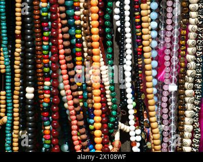 Colorful necklaces for sale in a fair. Art and crafts background or texture. Stock Photo