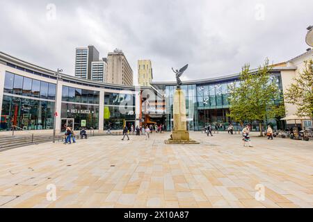 Jubilee Square war memorial and the entrance to the Peacocks shopping centre and Market Walk in Victoria Place in the town centre of Woking, Surrey Stock Photo