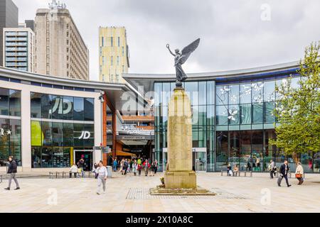 Jubilee Square war memorial and the entrance to the Peacocks shopping centre and Market Walk in Victoria Place in the town centre of Woking, Surrey Stock Photo