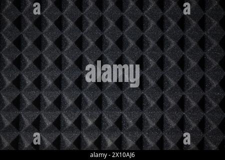 Background of sound absorbing sponge. Wall soundproofing. Pyramid style padding layer panel for voice recording. Close-up. Stock Photo
