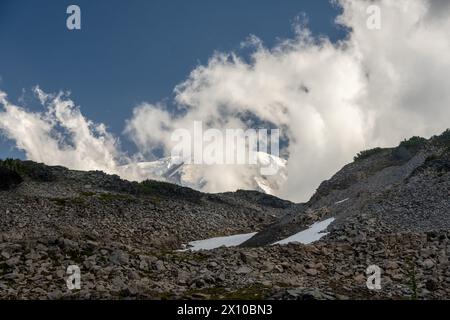 Looking Up To A Cloudy Mount Rainier From Spray Park on summer afternoon Stock Photo