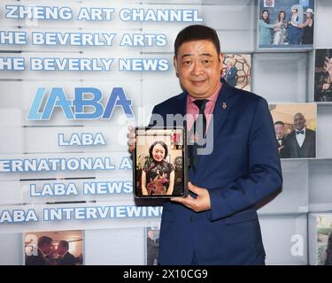 Beverly Hills, California, USA. 9th April, 2024. TV host Joey Zhou, founder of the Los Angeles Beverly Arts (LABA), interviews Chinese artist Chun Liu by video conference (iPad) at Pink Moon Restaurant in Beverly Hills, California. Credit: Sheri Determan Stock Photo