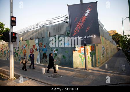 Tehran, Iran. 14th Apr, 2024. people walk past a poster depicting Iranian missiles in downtown Tehran, Iran on Sunday, April 14, 2024. Israel on Sunday hailed its air defenses in the face of an unprecedented attack by Iran, saying the systems thwarted 99% of the more than 300 drones and missiles launched toward its territory. (Photo by Sobhan Farajvan/Pacific Press) Credit: Pacific Press Media Production Corp./Alamy Live News Stock Photo