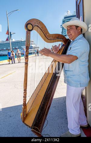 Costa Maya Mexico,Cruise Port,Norwegian Joy Cruise Line ship,7-day Caribbean Sea itinerary,Hispanic man musician,playing harp,entertaining arriving pa Stock Photo