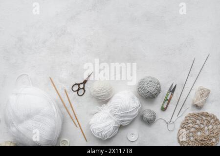 Knitting needles, yarn balls and scissors on white background Stock Photo
