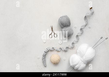 Yarn balls, scissors and knitting accessories on white background Stock Photo
