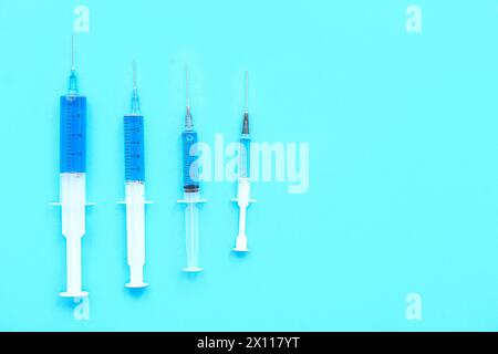 Medical syringes with medicine on blue background Stock Photo