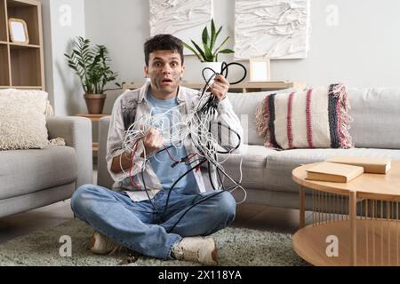 Electrocuted man with burnt face and wires at home Stock Photo