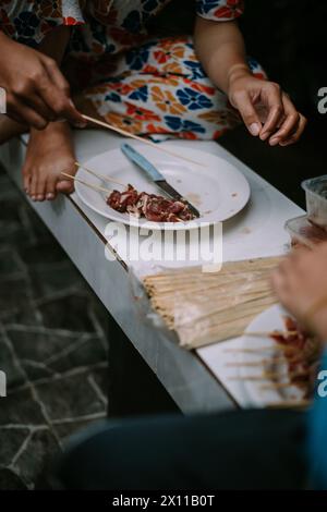 Slices of meat are prepared on skewers and then grilled on a meat grill. Stock Photo