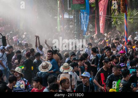 Water is sprayed onto a densely packed crowd during The Cambodian New Year festival. Wat Phnom, Phnom Penh, Cambodia. © Kraig Lieb Stock Photo