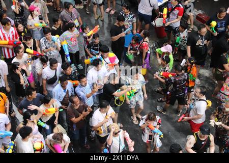 Bangkok, Thailand - April 14, 2024 : People celebrating Songkran festival on Si Lom Rd. Water festival in Thailand. Stock Photo