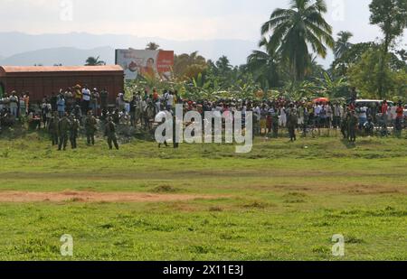 Local Haitians gather around the helicopter landing zone, secured by Marines from Lima Company, Battalion Landing Team, 3rd Battalion, 2nd Marine Regiment, 22nd Marine Expeditionary Unit in Leogane, Haiti, Jan. 20, 2010. Stock Photo