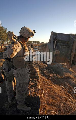 Seaman Vince E. Chu Lo, a corpsman for 2nd Combat Engineer Battalion, works with 2nd CEB Marines to build an observation post along route Cowboys, Helmand province Afghanistan, Jan. 7 2010. During operations on route Cowboys, 2nd CEB constructed three observation posts. Stock Photo