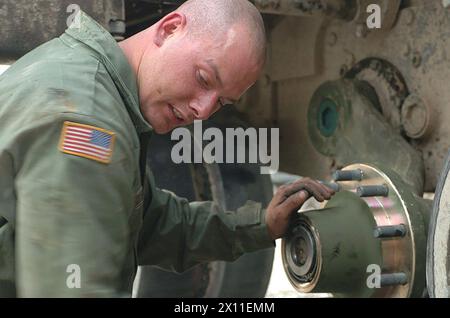 Original Caption: SGT Michael R. Curley from Alpha Company, 2nd Battalion 63rd Armor Regiment changes the number two arm of an M1A1 tank ca. February 04, 2004 Stock Photo