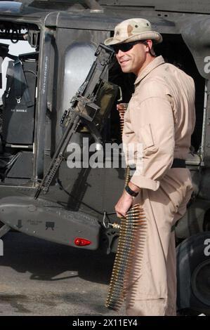 UH-60 Crew Chief Sgt. Bill McCullough with A Co., 1-171 AVN, Georgia Army National Guard, prepares for a mission into Iraq recently at the Camp Arifjan, Kuwait air field. McCullough mans a M-60 machine gun during flights into Iraq ca. 2004 Stock Photo