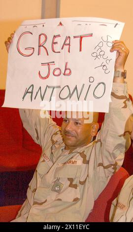 Chief Warrant Officer William Scott, battalion maintenance officer assigned to Headquarters and Headquarters Company, 123rd Main Support Battalion, cheers on his son, Antonio, from Freedom Rest in Baghdad, Iraq. Scott was able to watch Antonio on a Video Teleconference system as he graduated from General H.H. Arnold High School in Wiesbaden, Germany June 5 2004. Stock Photo