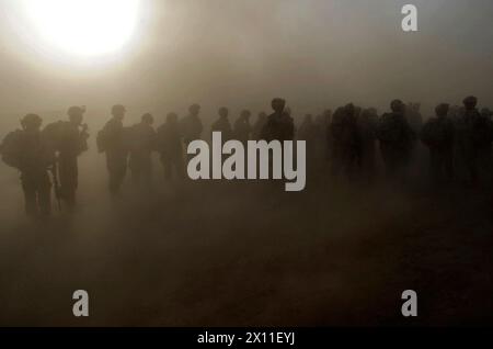 Paratroopers from the 1st Platoon, Company C, 1st Battalion, 501st Infantry Regiment, 4th Brigade Combat Team, 25th Infantry Division, wait in a dust storm for the beginning of an air assault mission at Forward Operating Base Kushamond, Afghanistan ca. September 07, 2004 (metadata lists year as 2009) Stock Photo
