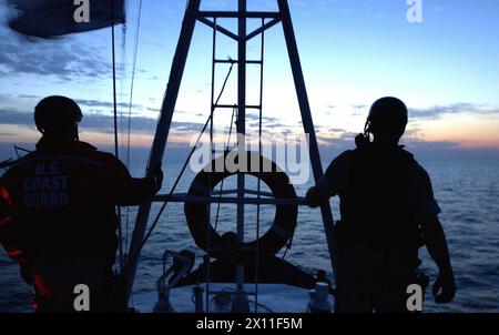 ARABIAN GULF (Jan. 4, 2004)--Members of a boarding team from the U.S. Coast Guard Cutter Adak search a merchant vessel for illegal goods. The Coast Guard has deployed four 110-foot patrol boats to the region to support U.S. Navy 5th Fleet and coalition forces during Operation Iraqi Freedom and Maritime Interception Operations to stop illegal oil smuggling and to search for terrorists. Stock Photo