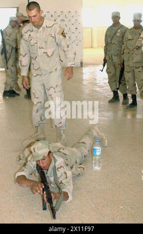 Sgt. Jessy Johnston coaches an Iraqi soldier on basic marksmanship ca. 2004 Stock Photo