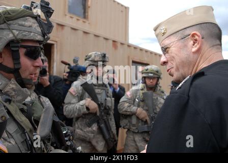 Original Caption: U.S. Navy Adm. Mike Mullen (right), chairman of the Joint Chiefs of Staff, speaks with Sgt. Joseph Smith of Des Moines, Iowa, and from Company A, 1st Combined Arms Battalion, 67th Armor Regiment, 2nd Brigade Combat Team, 4th Infantry Division, at Fort Carson, Mar. 10. Warhorse Soldiers of the 2nd BCT are currently conducting training to prepare them for their rotation at the National Training Center, Fort Irwin, Calif. ca. October 03, 2004 Stock Photo