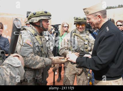 U.S. Navy Adm. Mike Mullen, chairman of the Joint Chiefs of Staff, gives his coin to Sgt. Michael Blauvelt, of Willow Springs, Mo., and from Company A, 1st Combined Arms Battalion, 67th Armor Regiment, 2nd Brigade Combat Team, 4th Infantry Division, at Fort Carson, Mar. 10 2004. Stock Photo