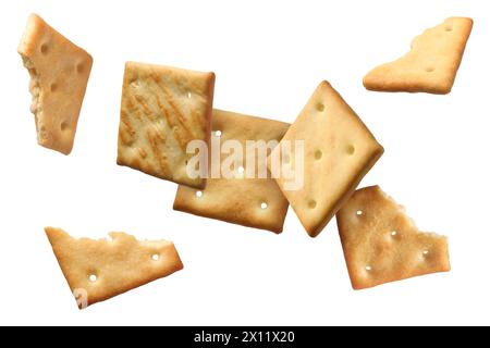 Tasty dry crackers falling on white background Stock Photo