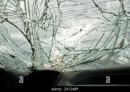 Broken glass texture, car windshield after traffic accident, shattered glass material background, selective focus Stock Photo