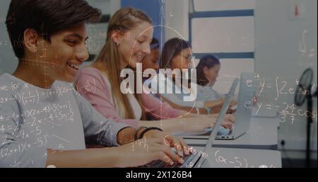 Image of math formulas moving over happy diverse pupils working on laptops Stock Photo