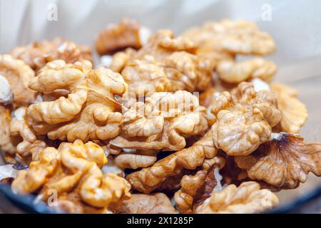 Shelled nuts background. Walnuts in a plate Stock Photo