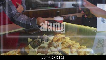 Image of spots of light over man serving coffee working in cafe Stock Photo