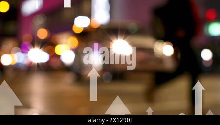 Image of up arrows over blurred vehicles stopped on signal and diverse people crossing street Stock Photo