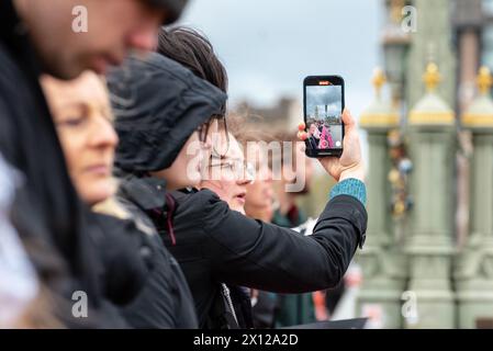 London, UK. 15 April 2024. Climate activists from Climate Resistance drop a banner from Westminster Bridge reading 'Stop Polluting Politics’. Credit: Andrea Domeniconi/Alamy Live News Stock Photo