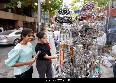 Two teenage girls looking at jewellery in a street market in   Bangalore, Bengaluru, Karnataka, India Stock Photo