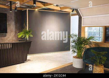 In modern office lounge, green plants adding life to space Stock Photo