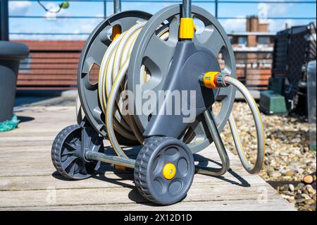 Jette, Brussels, Belgium, April 10, 2024 - A Hozelock garden hose for plant irrigation on a home terrace Stock Photo
