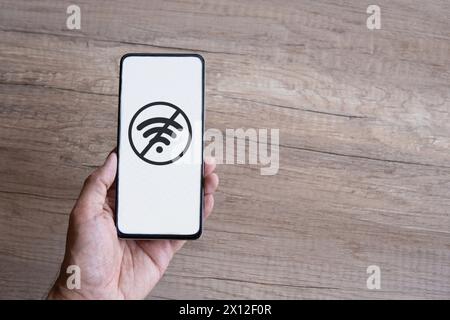 Top view image of hand holding smartphone without network access, no wi-fi icon. Copy space for text. Stock Photo