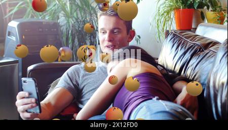 Image of media icons over happy caucasian couple using smartphone Stock Photo