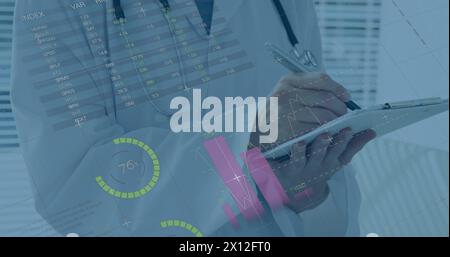 Image of financial graphs over midsection of caucasian male doctor making notes Stock Photo