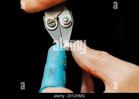 Close up of jewelers hands working with pliers on back background Stock Photo