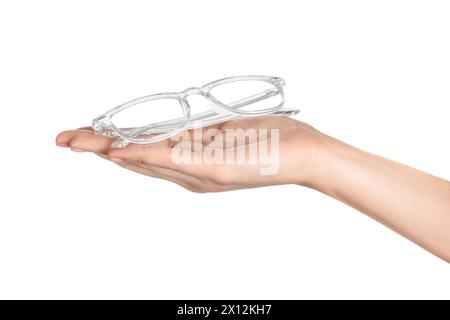 Woman holding glasses with transparent frame on white background, closeup Stock Photo